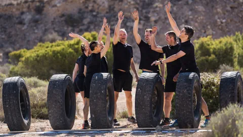 7 Menschen in schwarzer Sportkleidung.