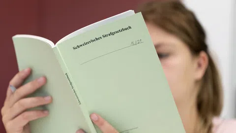 Frau liest im Strafgesetzbuch