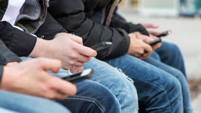 Junge Männer mit Smartphones