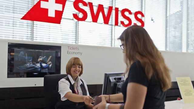 Swiss counter, a woman registers.