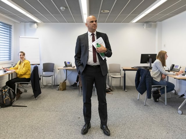 A man is standing in the middle of a room.