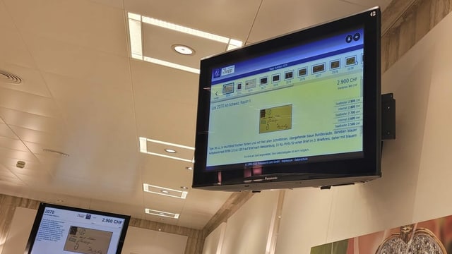 The auction is broadcast on a screen