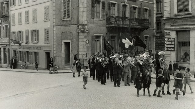 Schwarz-Weiss-Foto: Eine Prozession geht durch die jurassische Gemeinde