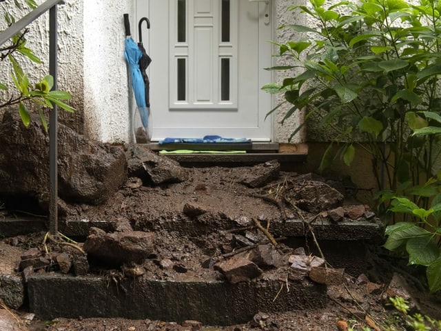 Boulders and mud to the front door, after a landslide in Bissone, in the Lugano district.