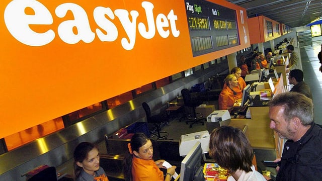 Passagiere am EasyJet-Check-in-Schalter