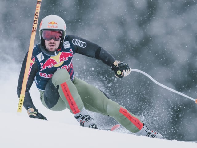 Skifahrer in Aktion während eines Rennens im Schnee.