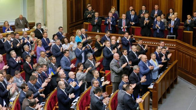 Parlament in Kiew, Abgeordnete stehen und applaudieren.