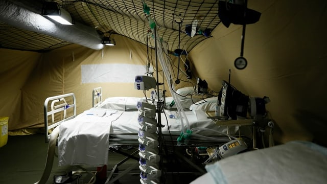 Intensive care beds in an army tent.