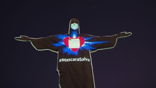 Light illustration with mask on the statue of Jesus in Rio de Janeiro.