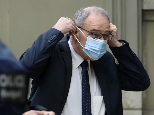 Guy Parmelin puts on a hygienic mask