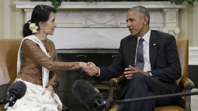 Man and woman shake hands.