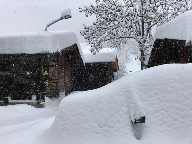 Snow covered car in Goms