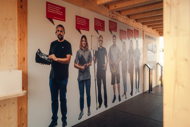 An dieser Wand sind SRF-Mitarbeiter:innen abgebildet, die ihren Beruf vorstellen. 