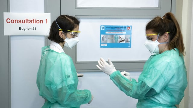 Nursing staff in the hallway of a hospital.