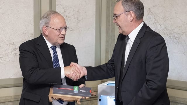 Parmelin verabschiedet Schneider-Ammann mit einem Händedruck.