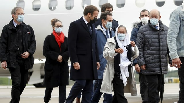 Macron accompanied by the 75-year-old development worker