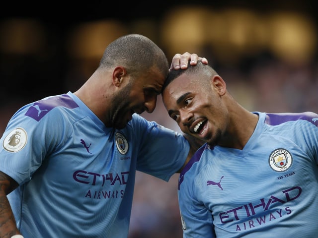 Gabriel Jesus and Kyle Walker hug.