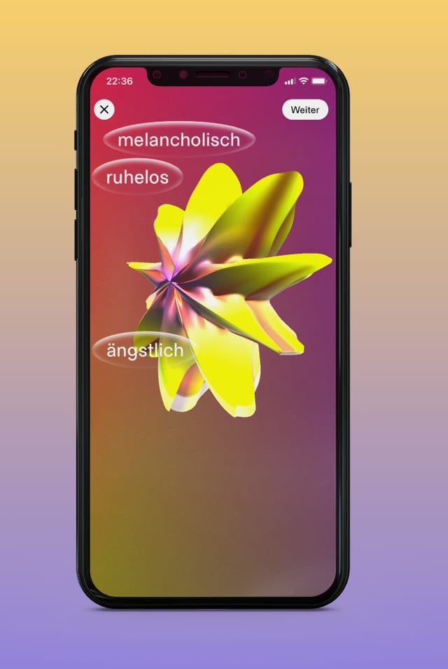 Ein Handy mit einer gelben, blumenartigen Form und den Begriffen ängstlich, melancholisch und ruhelos darauf.