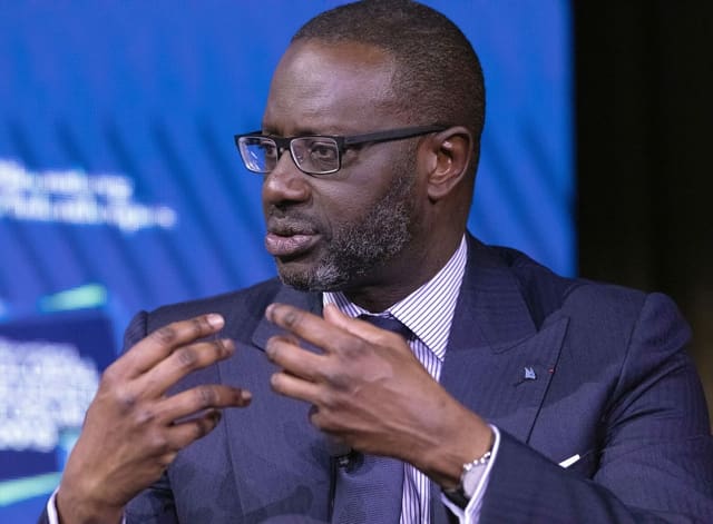 Portrait of Tidjane Thiam with gesturing hands.