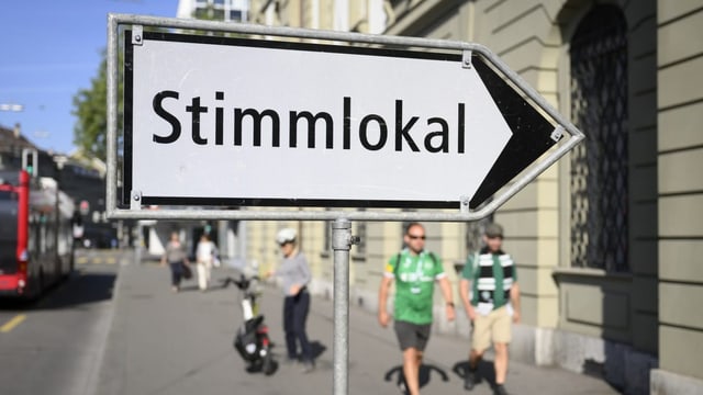 Auf einem Schild mit Pfeil steht die Aufschrift «Stimmlokal».