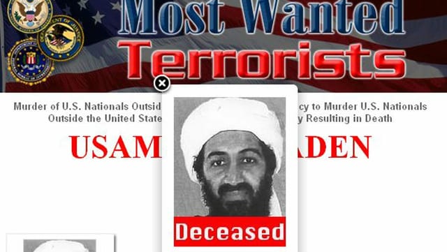 Photo of a screen of the US authorities with a photo of Osama bin Laden and the inscription 