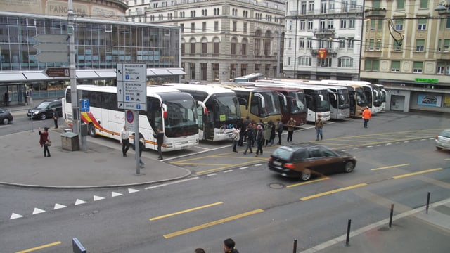 Mehrere Cars stehen auf dem Löwenplatz in Luzern. 