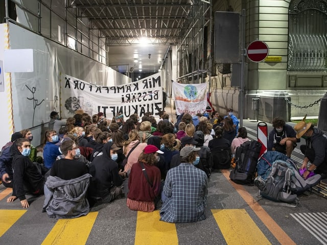 Activists sit on a street