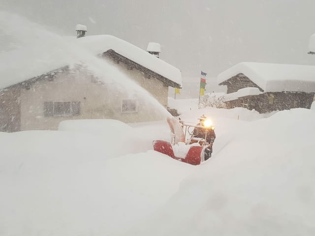 Man with snow plow shovels a free path.