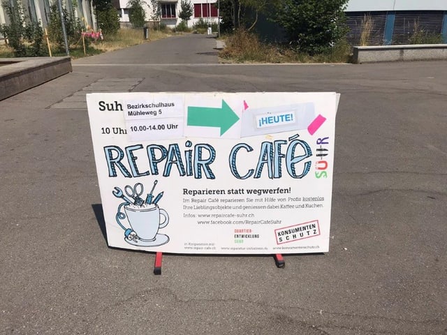 Foto von einem gebatelten Strassenschild, dass die Richtung des Repair Cafés anzeigt.