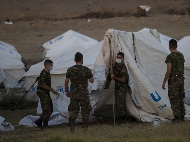 Military personnel are setting up temporary migrant shelters on Lesbos.