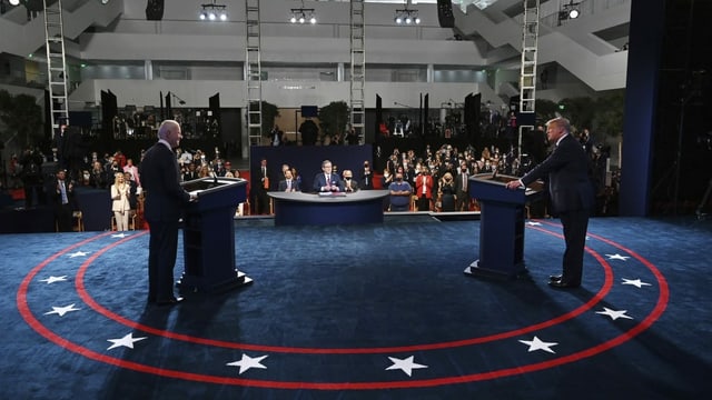 Trump and Biden are behind a lectern in the debate.