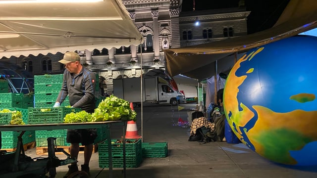 A salesman installs his sales stand