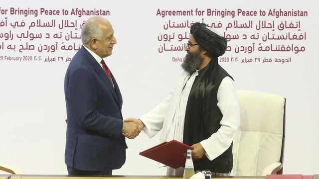 US peace envoy Zalmay Khalilzad (left) and Taliban envoy Mullah Abdul Ghani Baradar after the two sides signed an agreement.