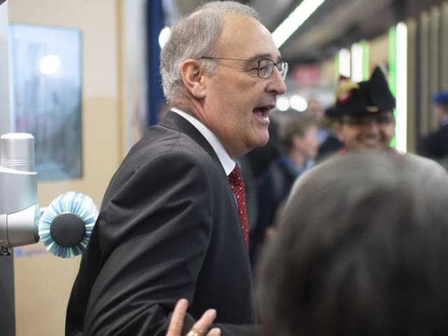 Bundespräsident Guy Parmelin testet eine Massagebürste für Kühe.