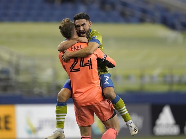 Stefan Frei and Cristian Roldan cheer.