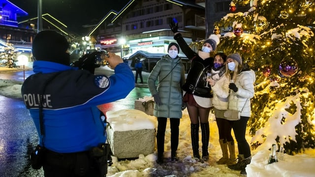 The police officer photographs a group of people