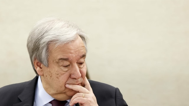 UN Secretary General António Guterres in a reflective mine.