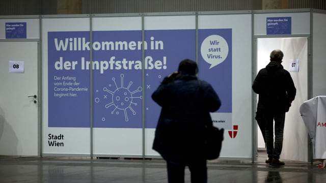 People enter a test station in Vienna.