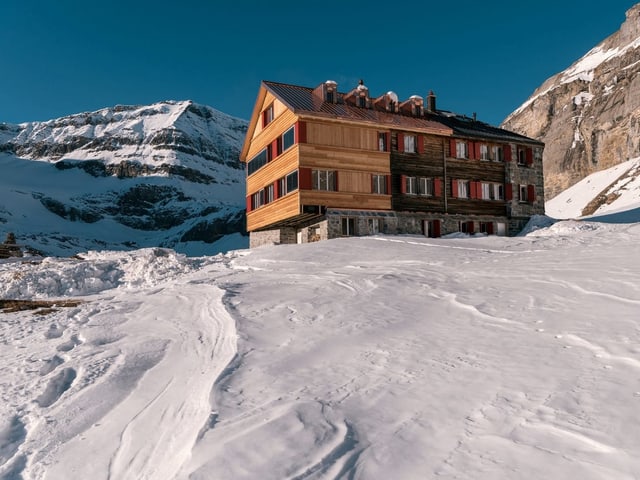 SAC-Hütte vor Bergen.