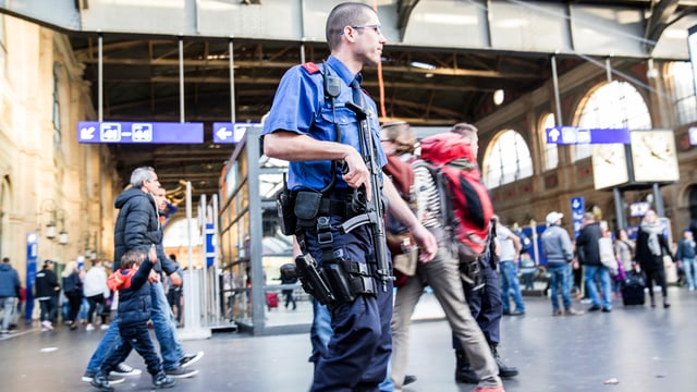 Bwaffneter Polizist patroulliert in der Halle des Zürcher Hauptbahnhofs