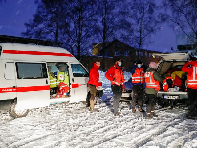 Rescue workers in the snow.