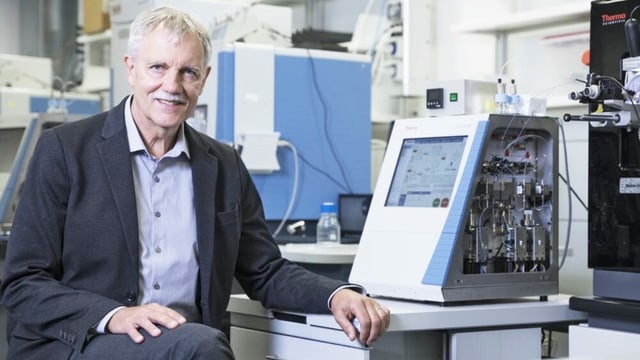 Man sitting in front of computer in laboratory