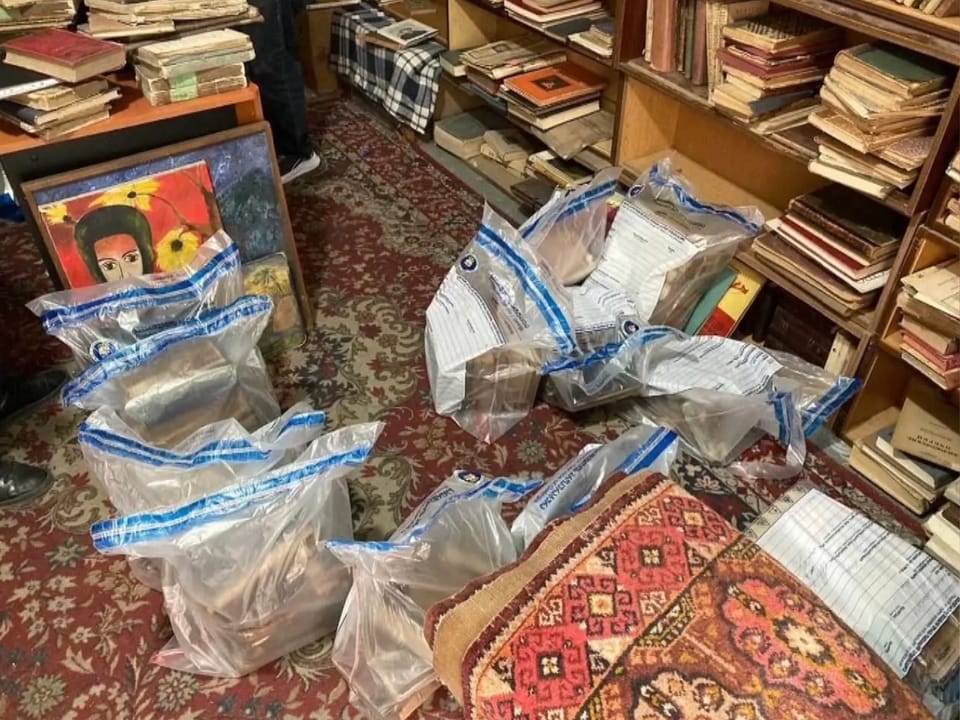 Mehrere vakuumversiegelte Pakete in einem Raum mit Büchern und Teppichen.