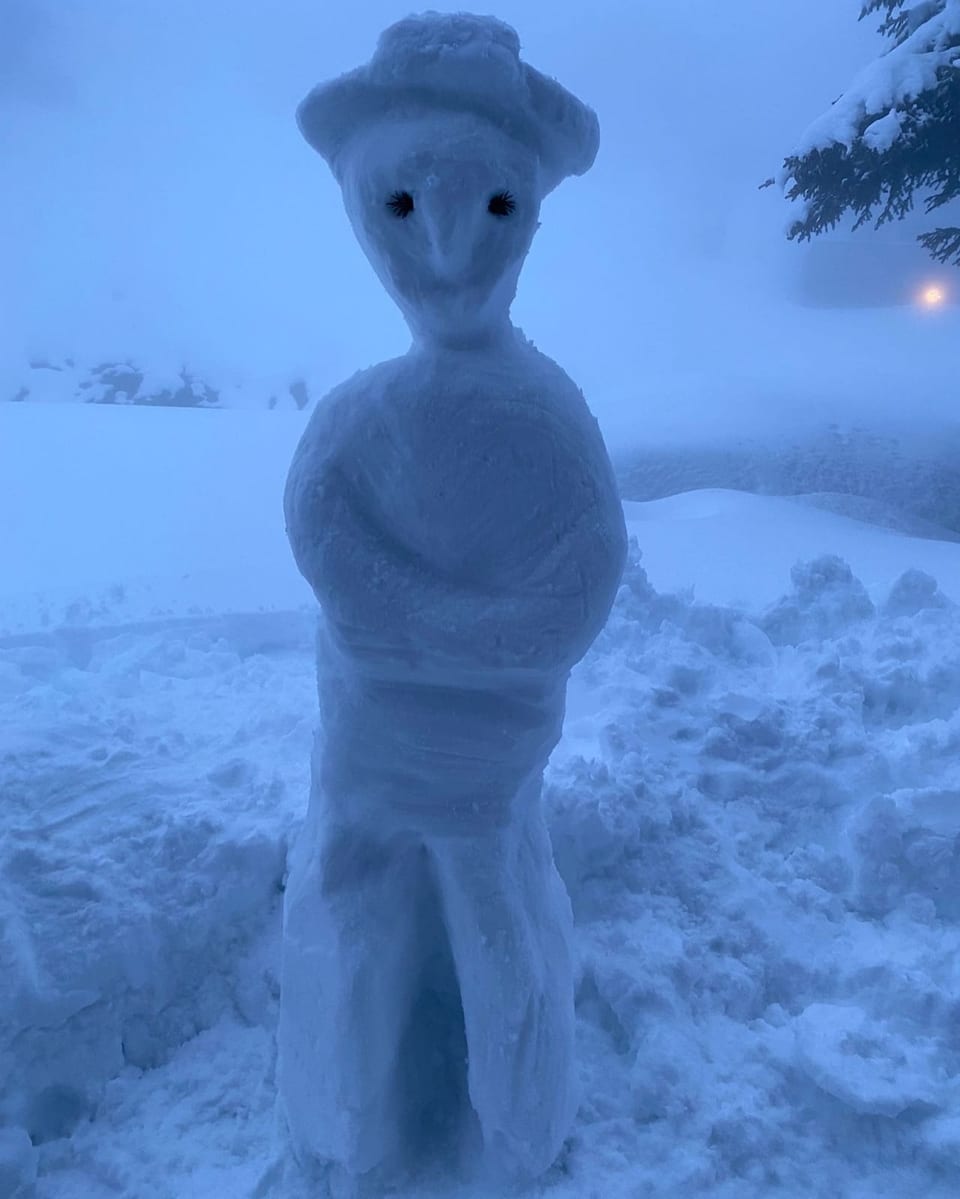 Schneemann mit aus Schnee geformtem Hut.