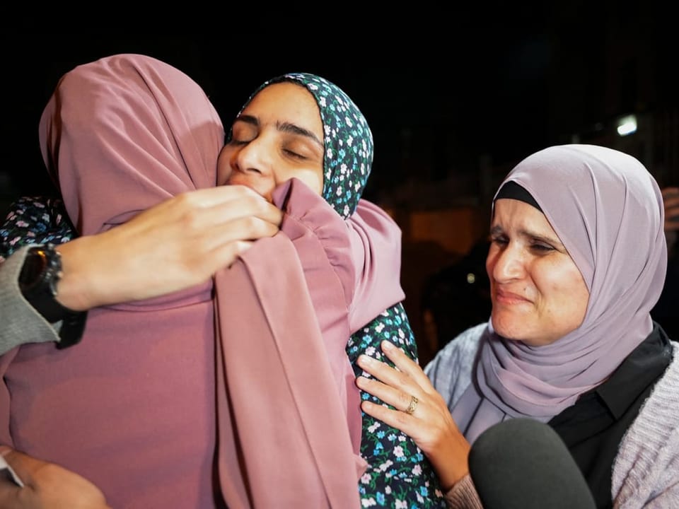 Eine palästinensische Ex-Gefangene liegt in den Armen einer anderen Frau.