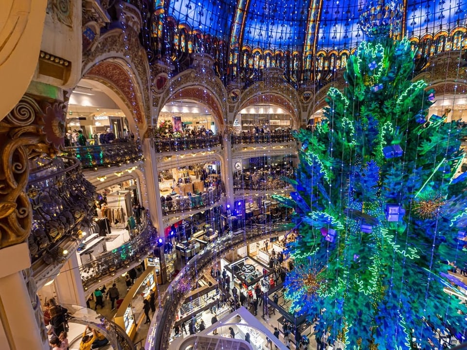 Weihnachtsbaum in Galerie mit geschmücktem Glasdach.