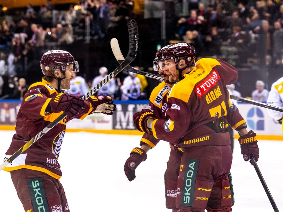 Eishockeyspieler jubeln auf dem Spielfeld.