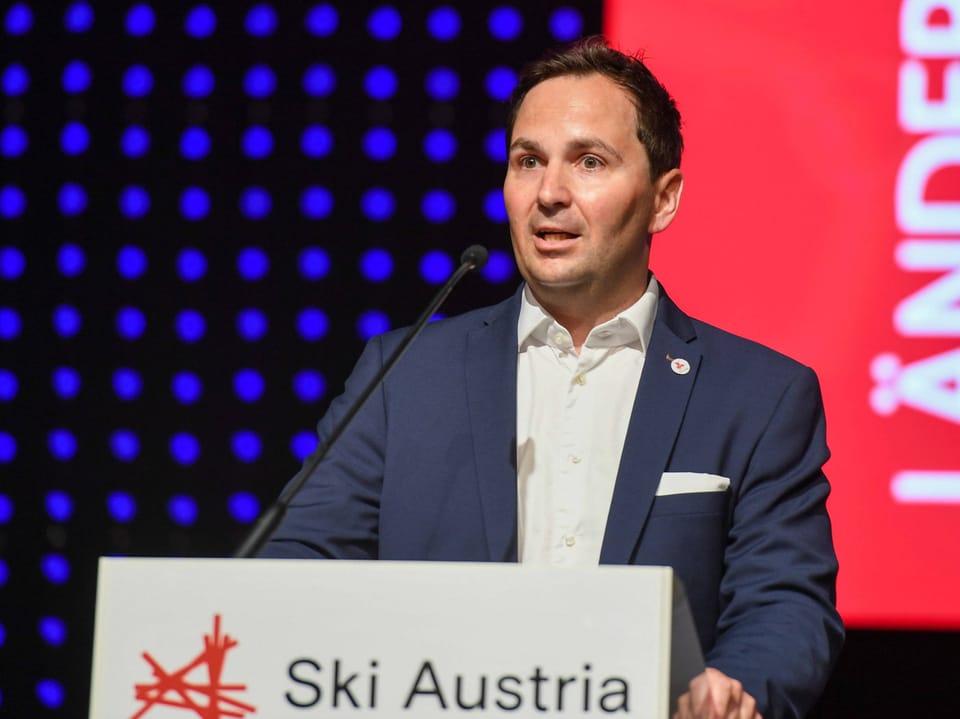 Mann spricht bei einer Veranstaltung von Ski Austria.