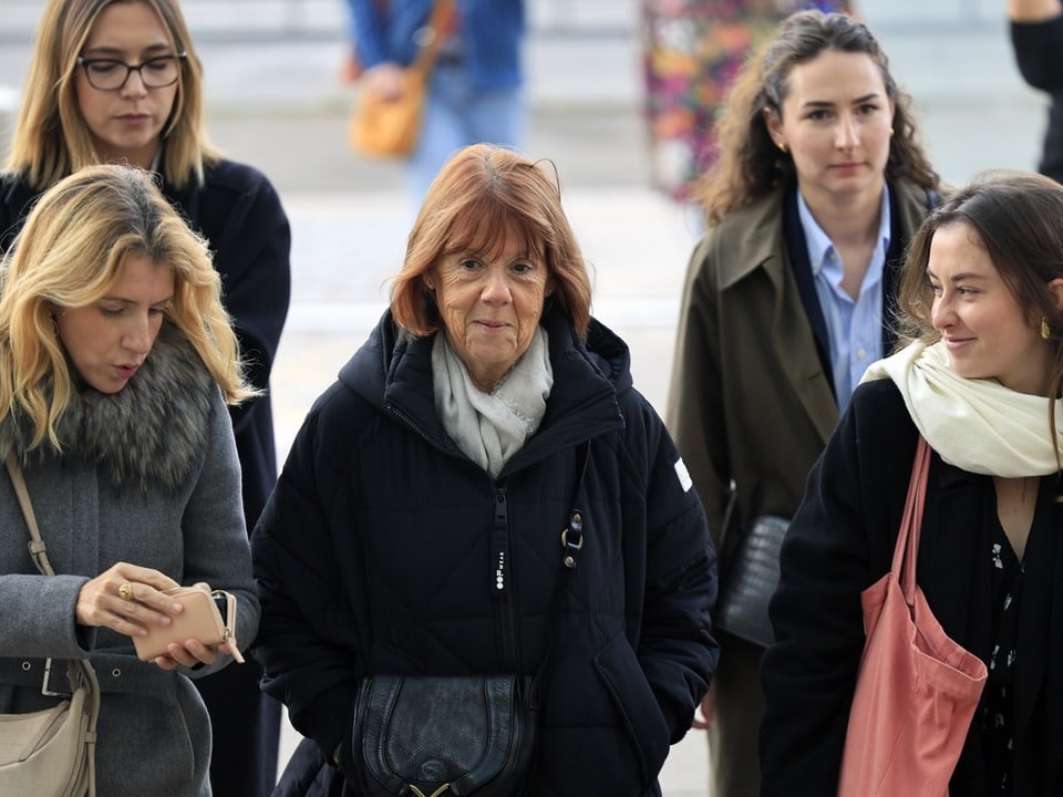 Fünf Frauen gehen draussen zusammen.