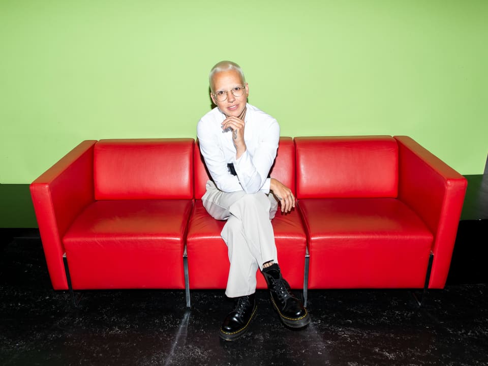 Stefanie Heinzmann on a red sofa in the SRF radio studio in Zurich.